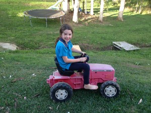 Holl on her mini tractor helping out